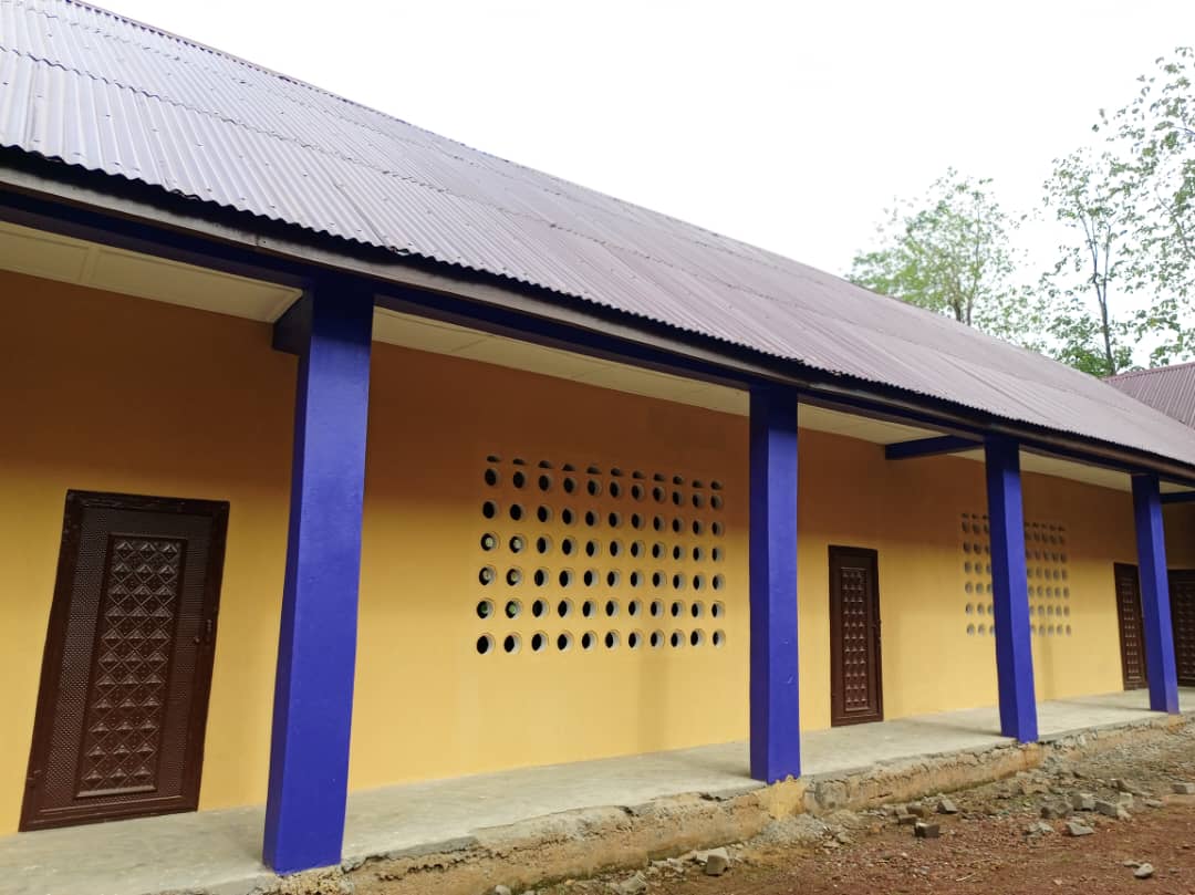 Exterior of the MGHS ten-classroom building, with yellow walls and purple columns